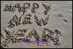 Habby New Year written on the beach